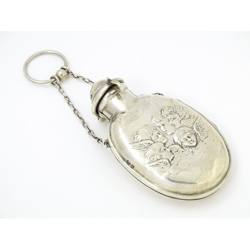 398 - A silver scent bottle cover with embossed angel detail, opening to reveal a green glass bottle withi... 