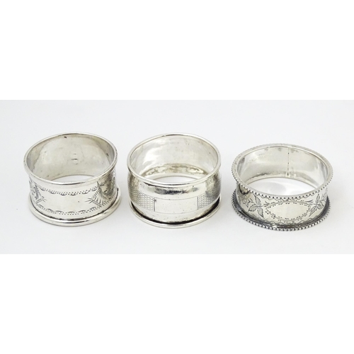 400 - Three assorted silver napkin rings with engraved decoration hallmarked Birmingham 1895, 1921 and 198... 