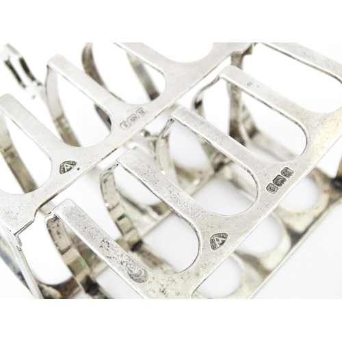 401 - A pair of silver four bar toast racks hallmarked Birmingham 1936, maker Adie Brothers Ltd. Approx. 3... 