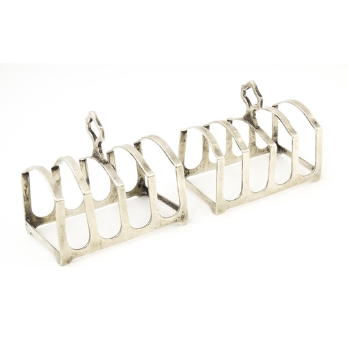 401 - A pair of silver four bar toast racks hallmarked Birmingham 1936, maker Adie Brothers Ltd. Approx. 3... 