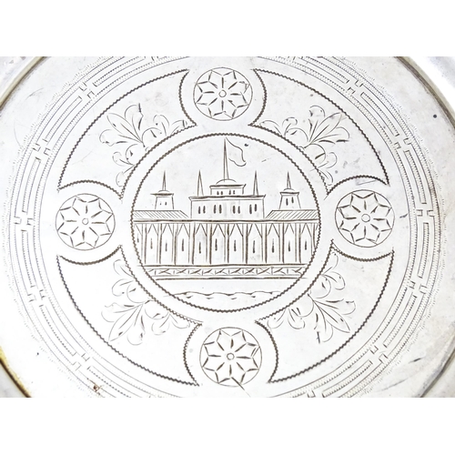 402 - A 19thC Russian silver dish with engraved decoration depicting a building with spires and flag. Appr... 