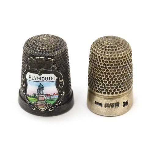 417 - A silver thimble hallmarked Chester 1921. Together with a silver plate example bearing crest for Ply... 