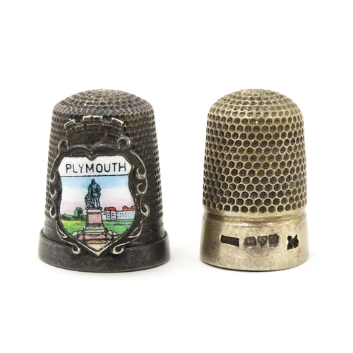 417 - A silver thimble hallmarked Chester 1921. Together with a silver plate example bearing crest for Ply... 