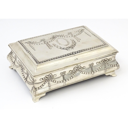 418 - A silver jewellery box with swag and bow detail, opening to reveal a silk lined interior, hallmarked... 