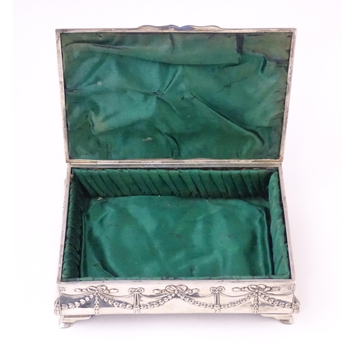 418 - A silver jewellery box with swag and bow detail, opening to reveal a silk lined interior, hallmarked... 