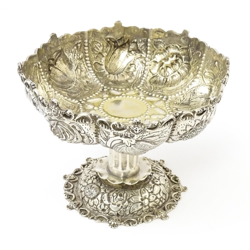 440 - A Victorian comport / tazza with embossed floral decoration, hallmarked London 1886, maker William C... 