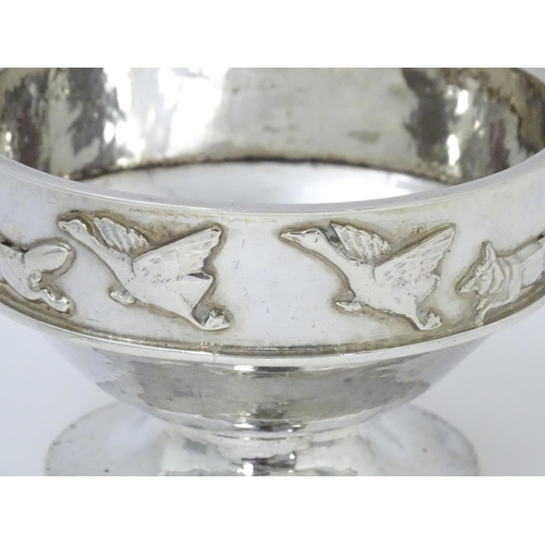 446 - Albert Edward Jones : An Arts & Crafts silver hammered pedestal bowl with banded relief decoration d... 