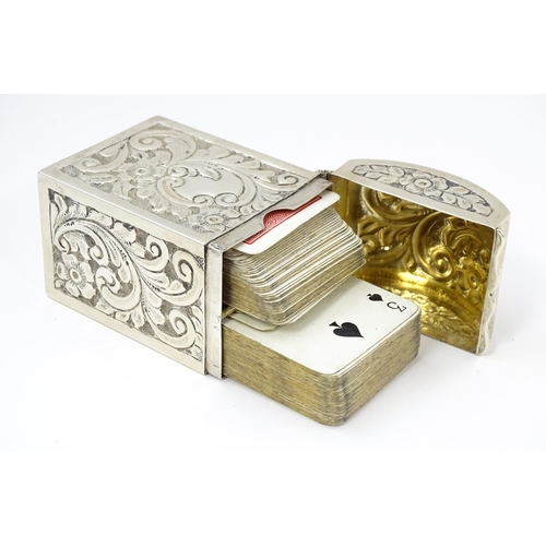 448 - A silver playing card box with embossed floral and foliate decoration and gilded interior, hallmarke... 