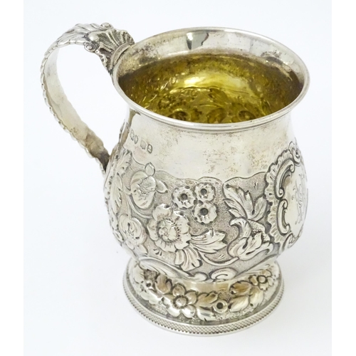 449 - A Geo IV silver Christening mug with embossed floral and foliate decoration with gilded interior, ha... 