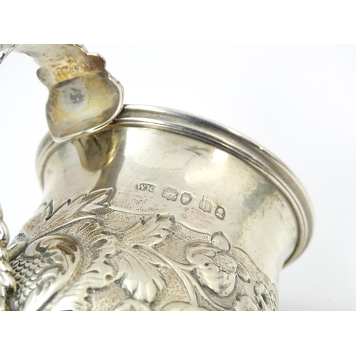 449 - A Geo IV silver Christening mug with embossed floral and foliate decoration with gilded interior, ha... 