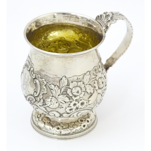 449 - A Geo IV silver Christening mug with embossed floral and foliate decoration with gilded interior, ha... 