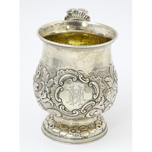 449 - A Geo IV silver Christening mug with embossed floral and foliate decoration with gilded interior, ha... 