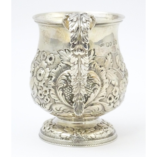 449 - A Geo IV silver Christening mug with embossed floral and foliate decoration with gilded interior, ha... 