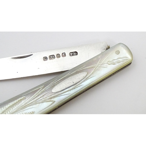 450 - A Victorian silver folding fruit knife with mother of pearl handle with engraved fern and foliate de... 