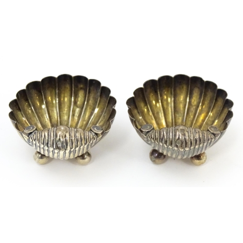 451 - A pair of Victorian silver salts and salt spoons of shell form, hallmarked Birmingham 1893, maker CB... 