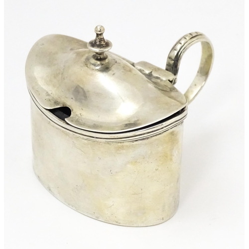 457 - A Geo III silver mustard pot of oval form with side mounted handle and blue glass liner, hallmarked ... 