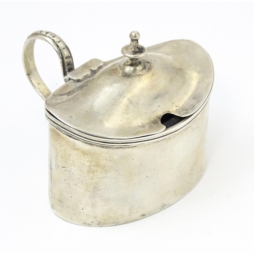 457 - A Geo III silver mustard pot of oval form with side mounted handle and blue glass liner, hallmarked ... 