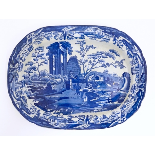 113 - An English blue and white dish of oval form in the Classical Ruins pattern. Approx. 15