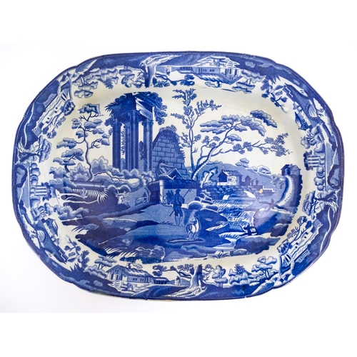 113 - An English blue and white dish of oval form in the Classical Ruins pattern. Approx. 15