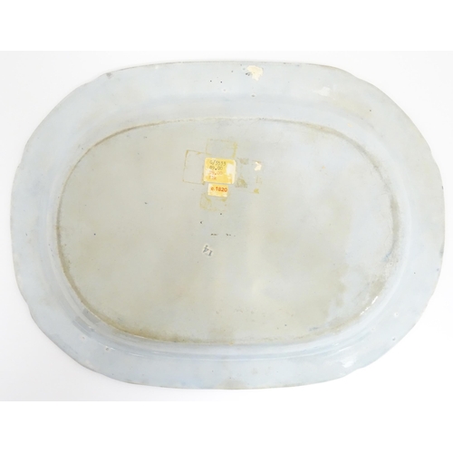 113 - An English blue and white dish of oval form in the Classical Ruins pattern. Approx. 15