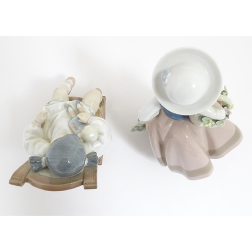 119 - Two Lladro figural group comprising Naptime no. 5448, and Sweet Scent no. 5221. With boxes. Largest ... 