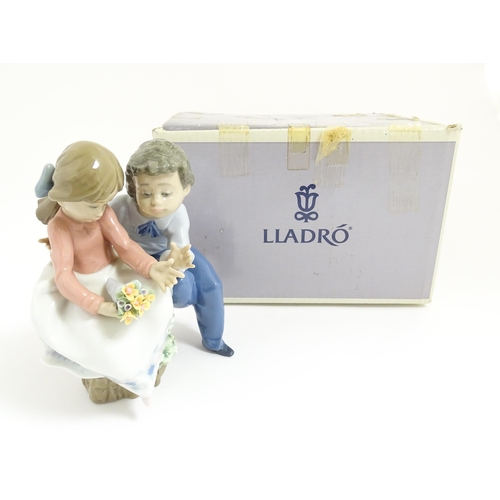 124 - A Lladro figure group Just a Little Kiss, no. 5701. With box. Approx. 5 1/2