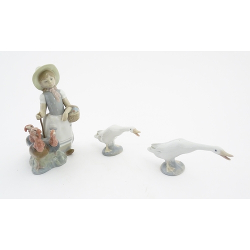 127 - Three Lladro models comprising Little Girl with Turkeys no. 1180, and two models of geese. Largest a... 