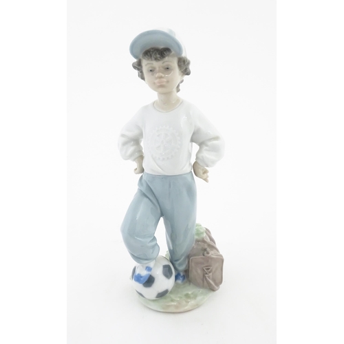 129 - A Lladro figure Starting Forward Football Boy, for Rotary International, no. 7605. Approx. 8 1/4