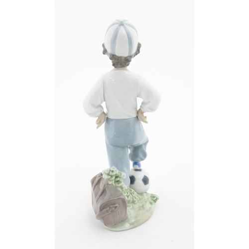 129 - A Lladro figure Starting Forward Football Boy, for Rotary International, no. 7605. Approx. 8 1/4