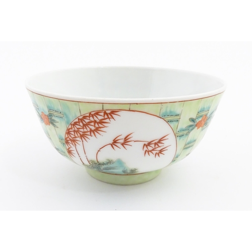 13 - A Chinese famille verte bowl decorated with stylised bamboo and flowers. Character marks under. Appr... 