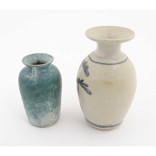 152 - Two items of studio pottery comprising a small vase with twin scroll handles and blue glaze by Paul ... 