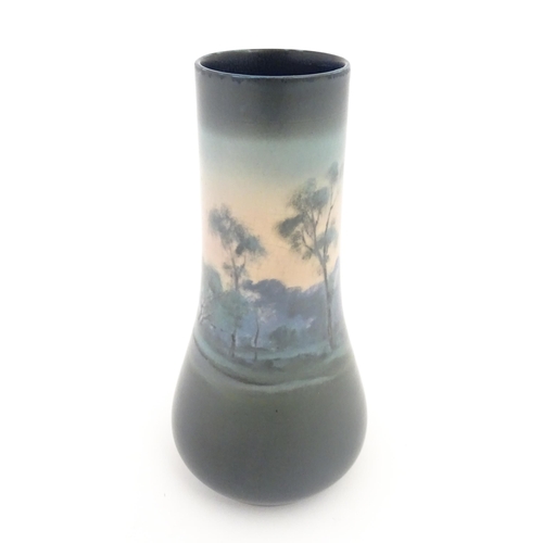 159 - A Rookwood Pottery vellum vase by Fred Rothenbusch with landscape decoration. Impressed marks under.... 