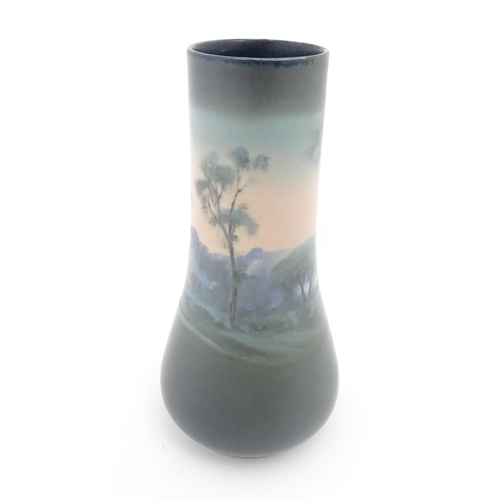 159 - A Rookwood Pottery vellum vase by Fred Rothenbusch with landscape decoration. Impressed marks under.... 