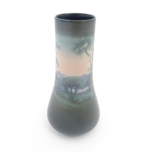 159 - A Rookwood Pottery vellum vase by Fred Rothenbusch with landscape decoration. Impressed marks under.... 