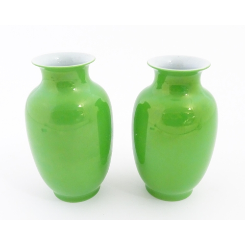 16 - A pair of Chinese vases with green glaze. Character marks under. Approx. 6 1/2