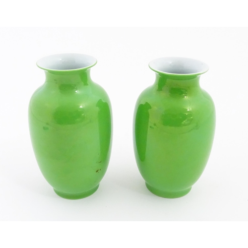 16 - A pair of Chinese vases with green glaze. Character marks under. Approx. 6 1/2