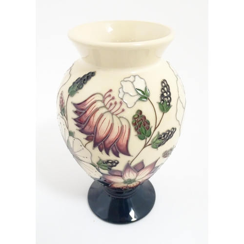 164 - A Moorcroft footed vase decorated in the Bramble pattern. Marked under. Approx. 7