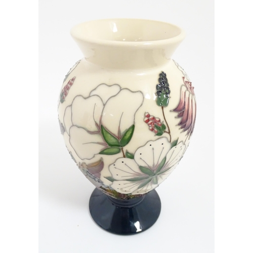 164 - A Moorcroft footed vase decorated in the Bramble pattern. Marked under. Approx. 7