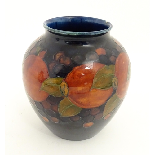 165A - A Moorcroft vase of baluster form decorated in the Pomegranate pattern. Marked under. Approx. 6