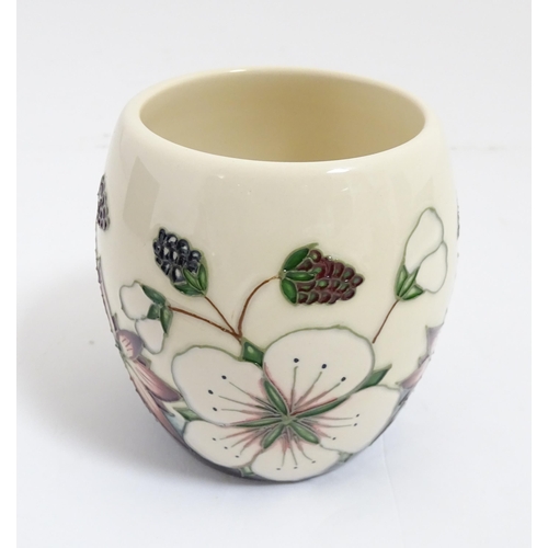 166 - A Moorcroft mug decorated in the Bramble pattern. With box. Marked under. Approx. 3 3/4