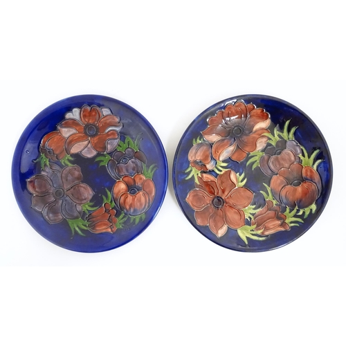 166A - Two Moorcroft plates decorated in the Clematis pattern. Marked under. Approx. 10 1/4