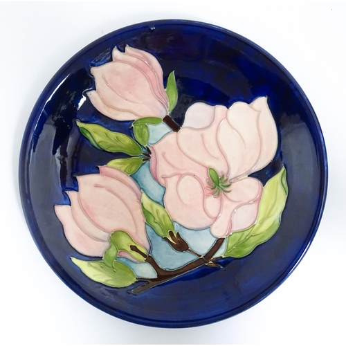 167 - A Moorcroft plate and small vase both decorated in the Magnolia pattern. Marked under. Vase approx. ... 