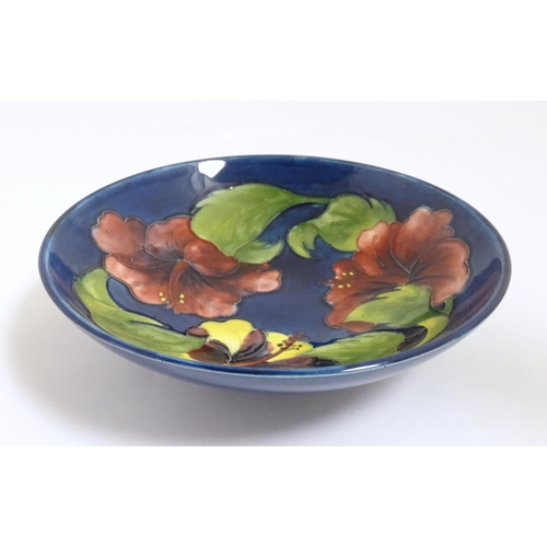 167A - A Moorcroft bowl decorated in the Hibiscus patter. Together with two Moorcroft ashtrays. Bowl approx... 