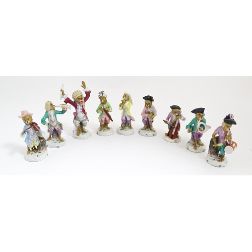 184 - Nine Continental porcelain monkey band 
/ orchestra figures modelled as monkey musicians with variou... 