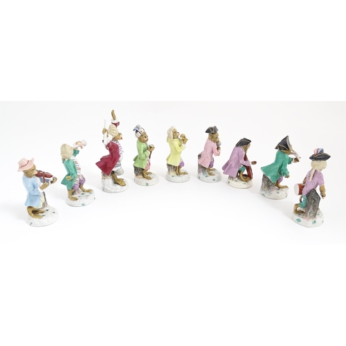 184 - Nine Continental porcelain monkey band 
/ orchestra figures modelled as monkey musicians with variou... 