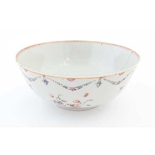 2 - A Chinese famille rose bowl decorated with floral garlands and flower motifs.  Approx. 4 1/4
