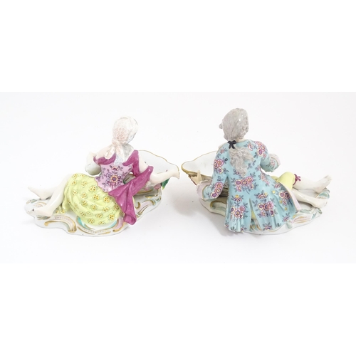 212 - A pair of Meissen style sweetmeat dish with figural detail. Crossed sword style mark under. Approx. ... 