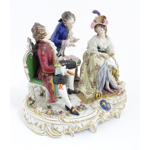 226 - A Thuringian porcelain Royal Court figure group modelled as a lady trying on shoes, with an attendan... 