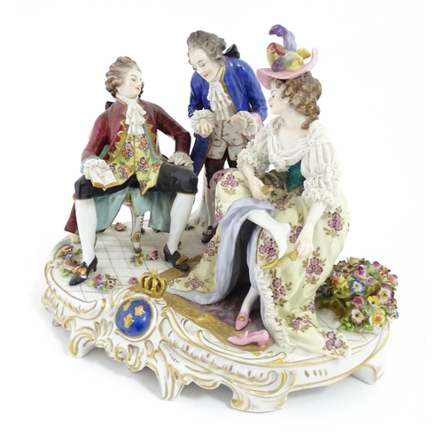 226 - A Thuringian porcelain Royal Court figure group modelled as a lady trying on shoes, with an attendan... 