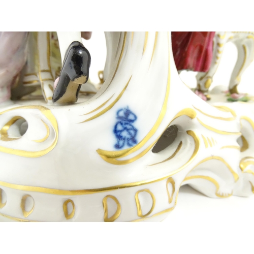 226 - A Thuringian porcelain Royal Court figure group modelled as a lady trying on shoes, with an attendan... 